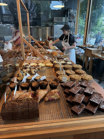 Rows and rows of various brownies, pastries, and cookies behind a glass case