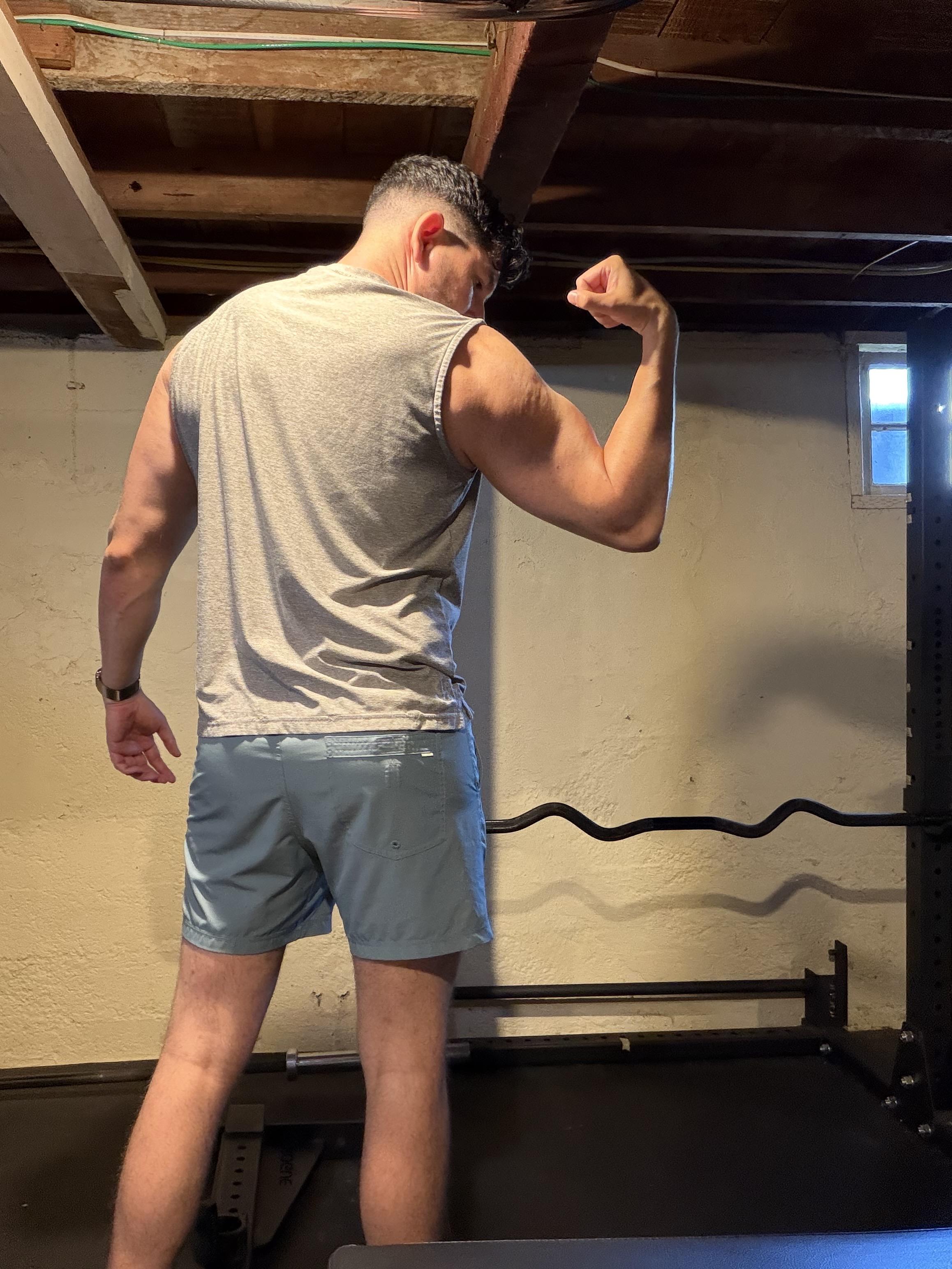 A back shot of me flexing a single arm, looking pretty broad